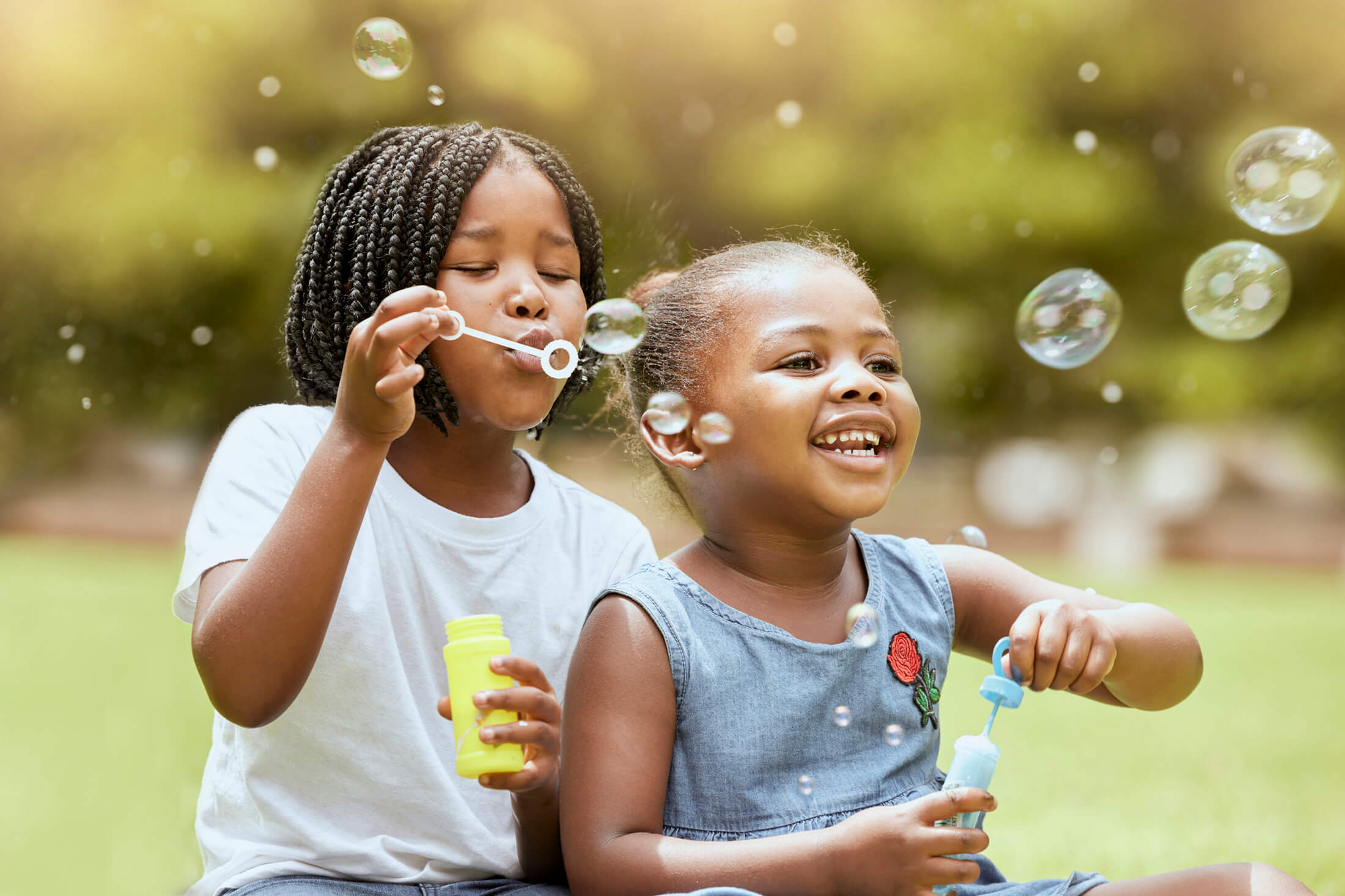 Two children blowing bubbles