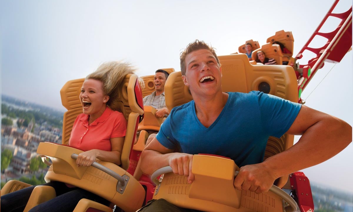 A man and woman enjoying a roller coaster ride at Universal Studios Florida