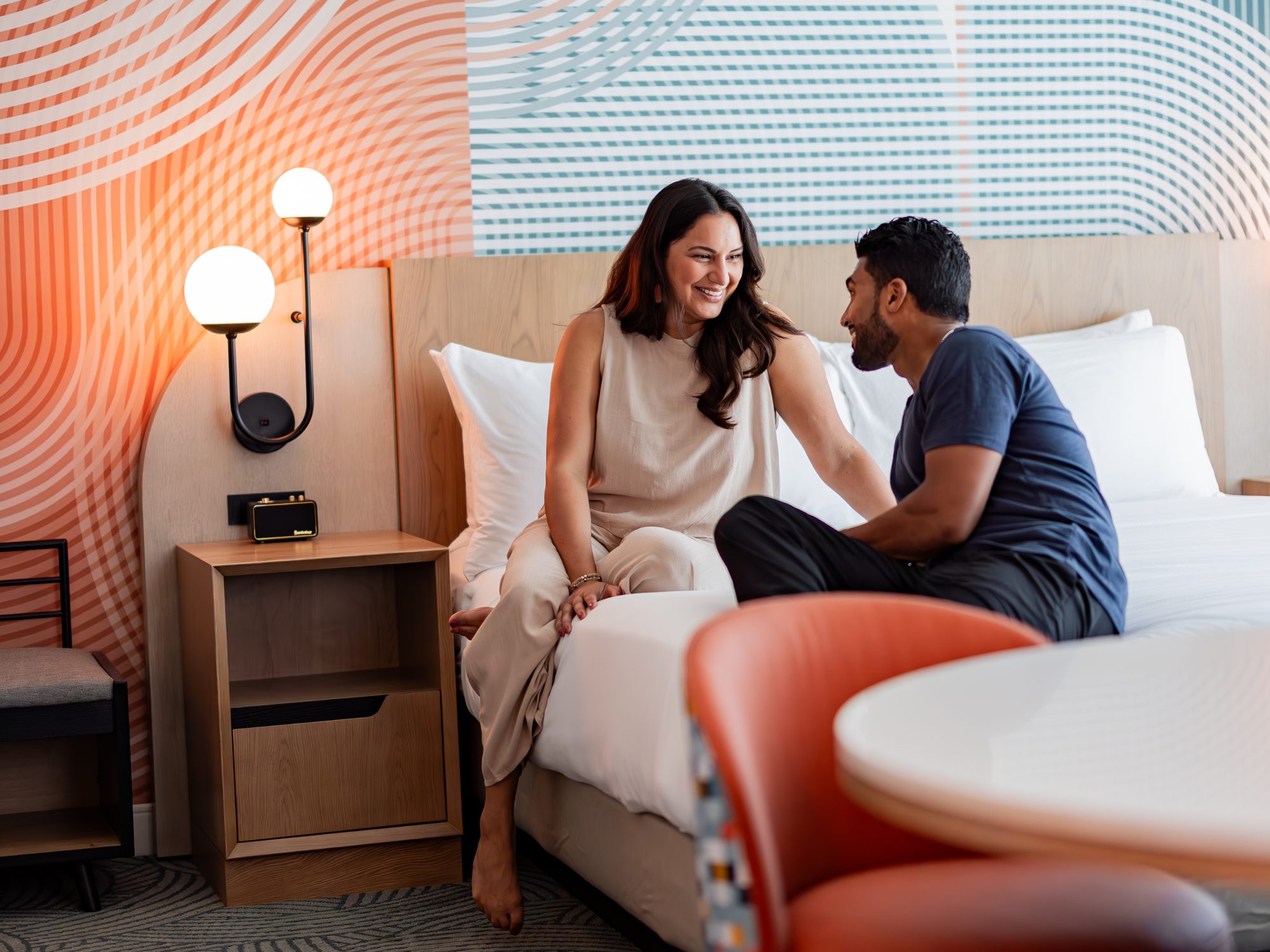 Couple sitting on a hotel bed