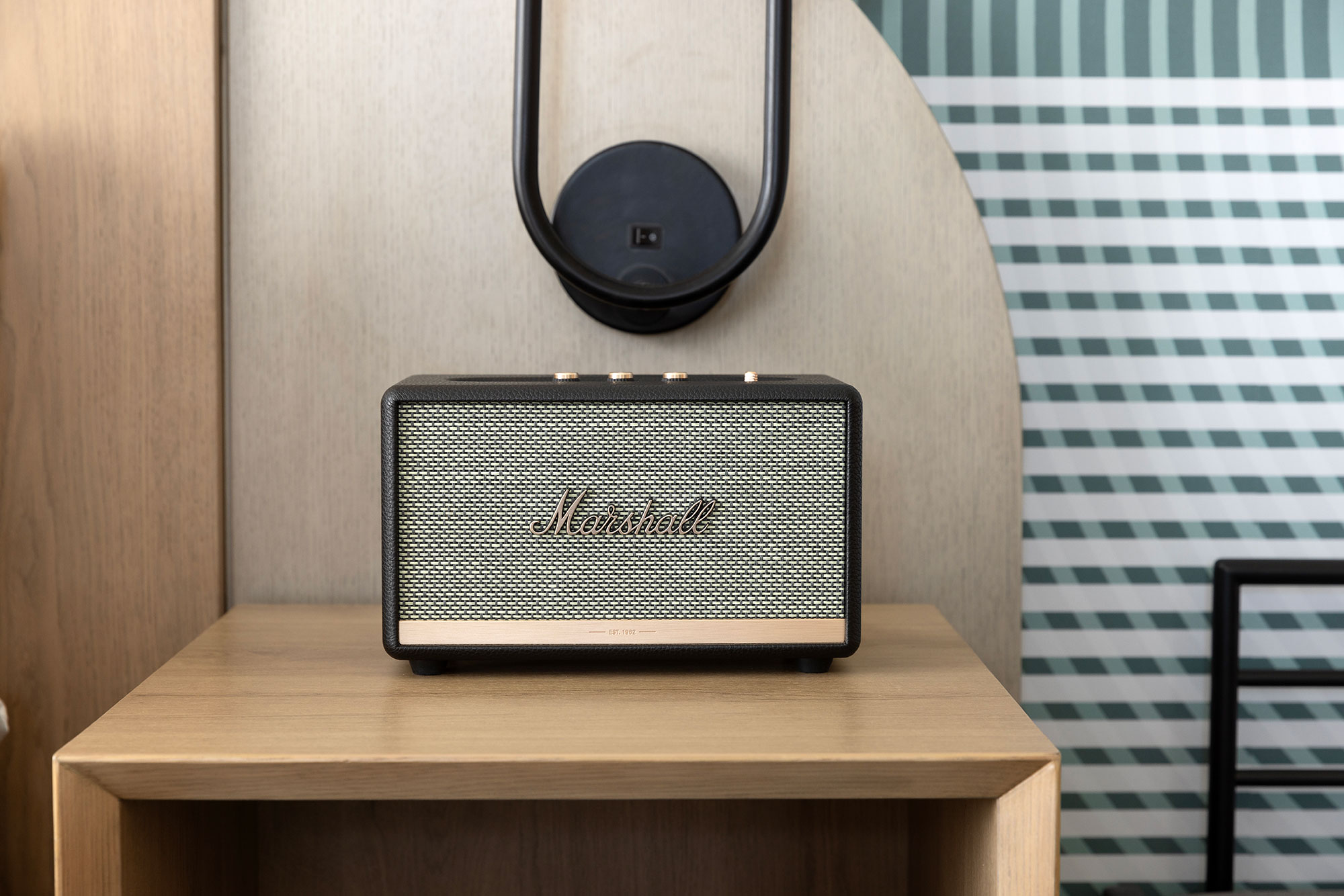 a speaker on the bedside table