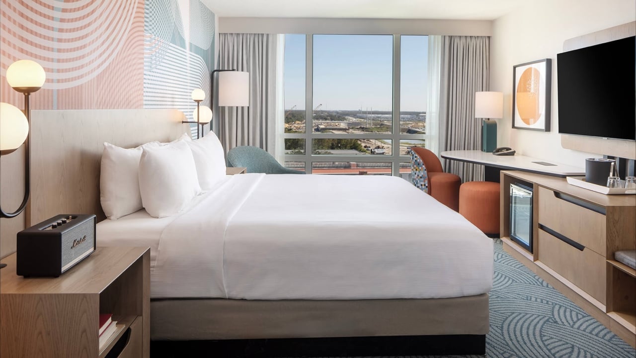 a spacious king bedroom with a large window at the end of the room