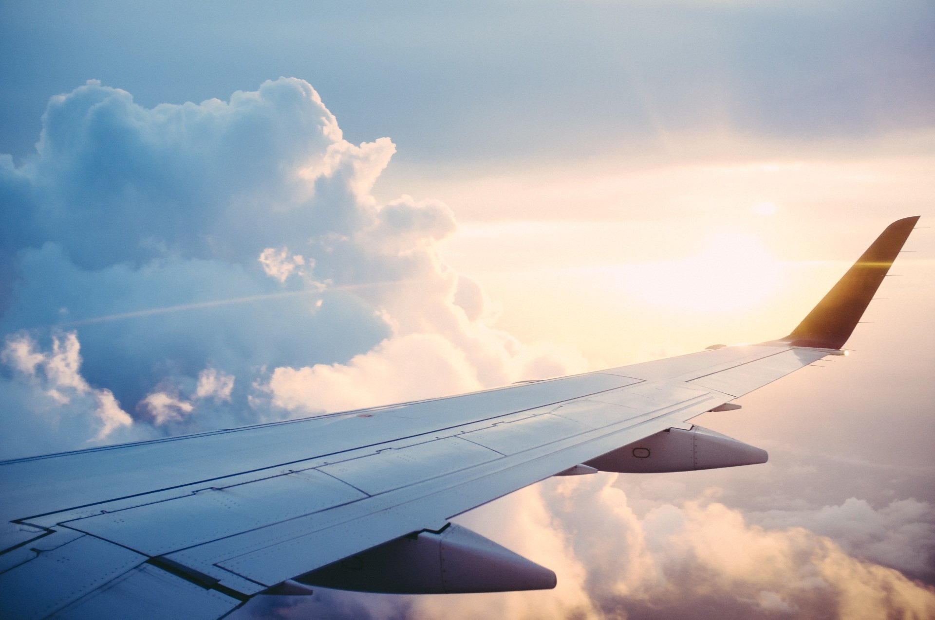 an aeroplane wing in the clouds