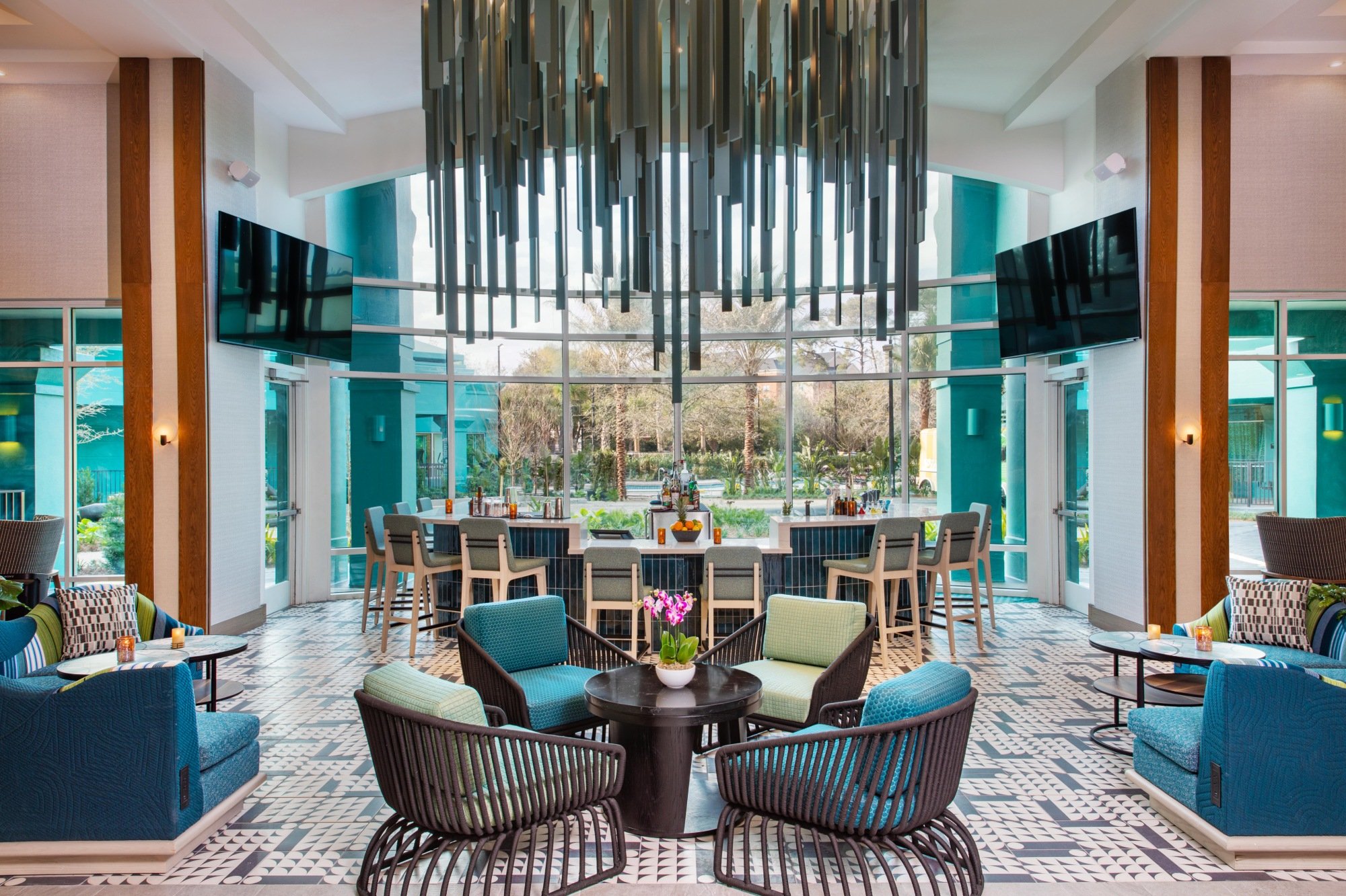 The entryway at Émilie Bar and Lounge. The room has large windows and a beautiful chandelier.