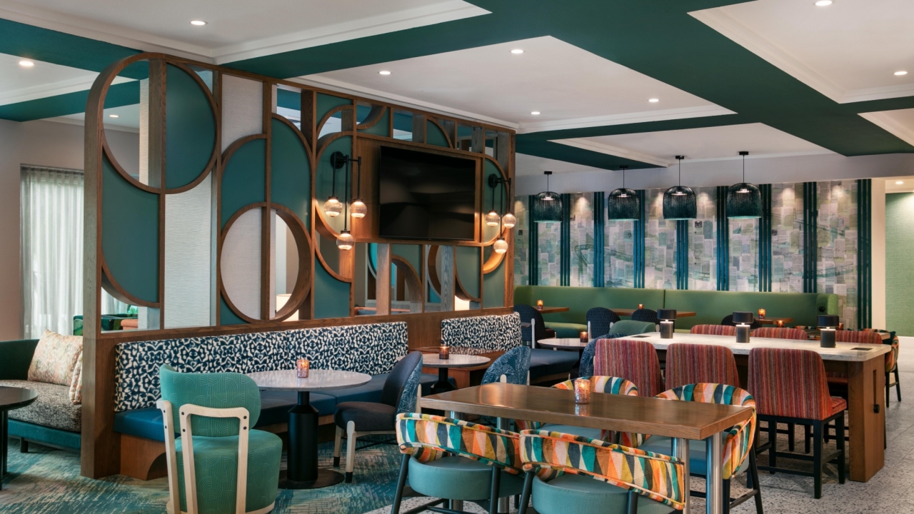 The colorful seating area at Orly's Market with tables and booths.