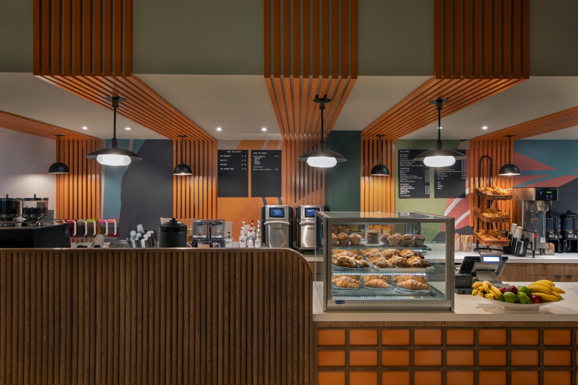 The grab and go counter at Orly's Market. On the counter is a display of pastries.