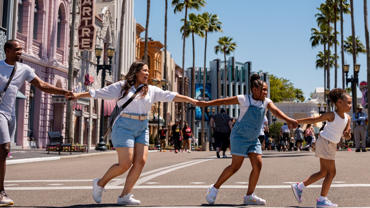 family holding hands crossing the street