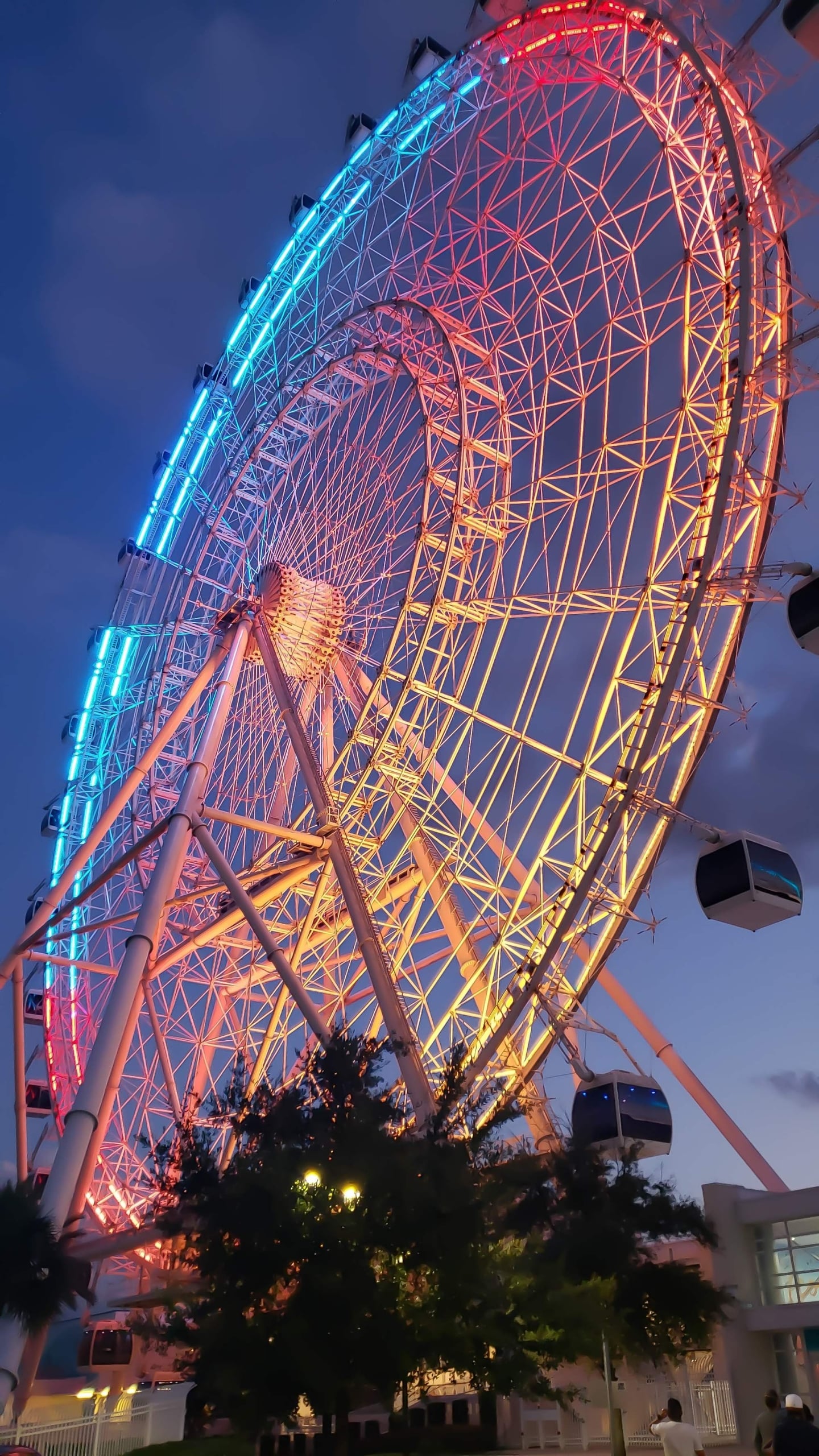 A colorful ferris wheel at night.