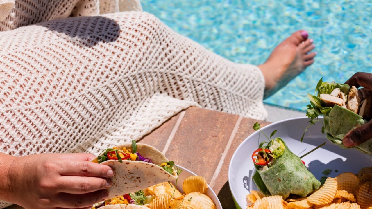 woman having snacks by a pool