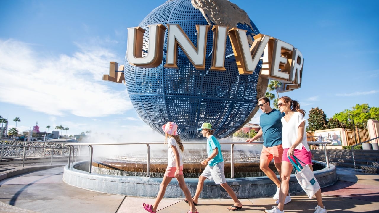 A family walking past the Universal globe