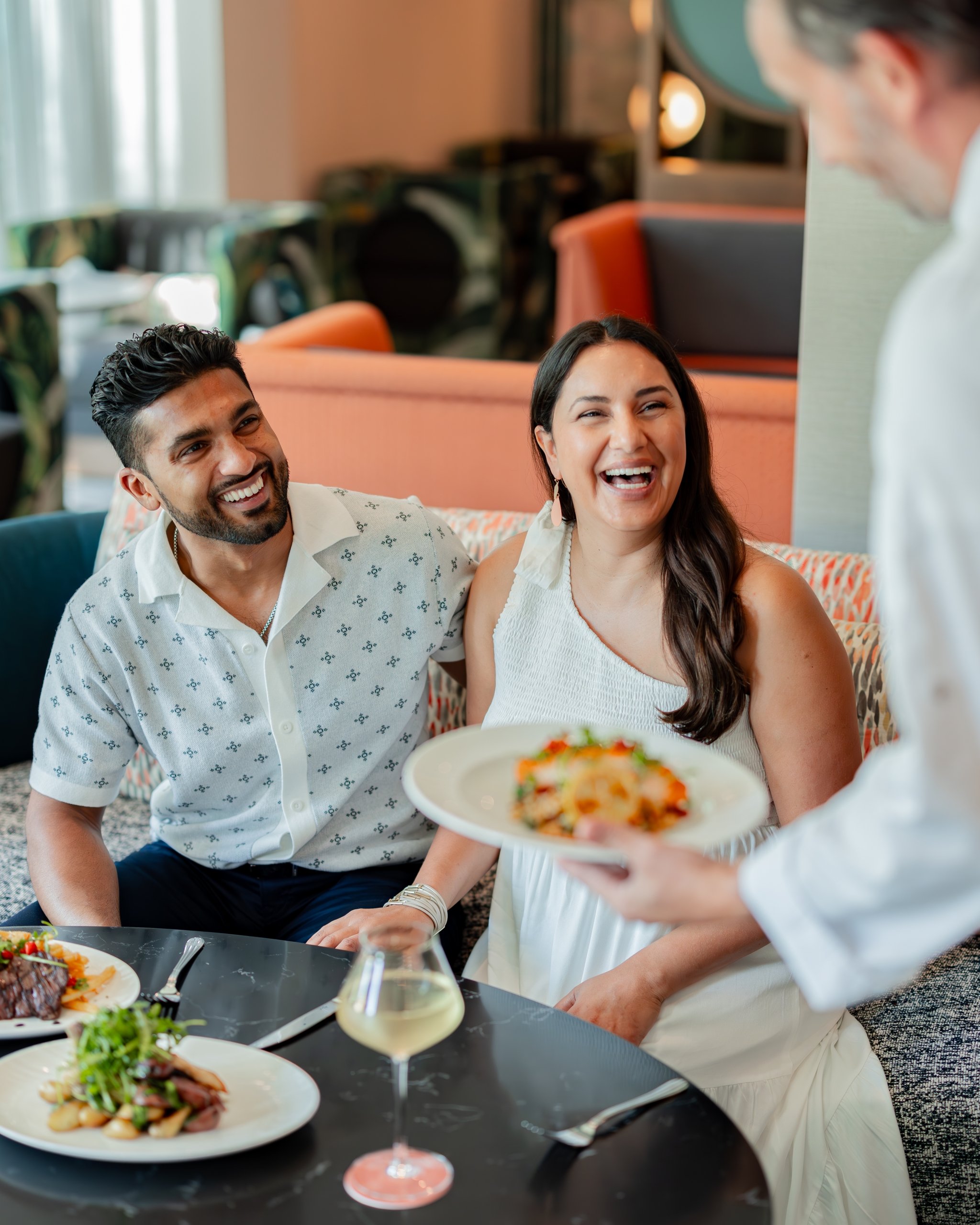 Couple at a restaurant being served food