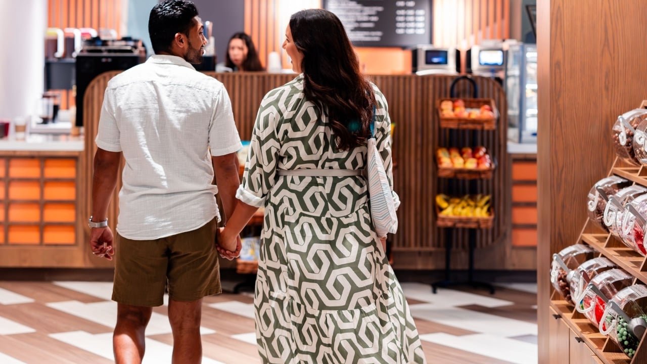 A couple walking towards a cafe
